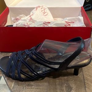 Brand new ladies navy dress shoes. Never worn. Strappy with elastic back